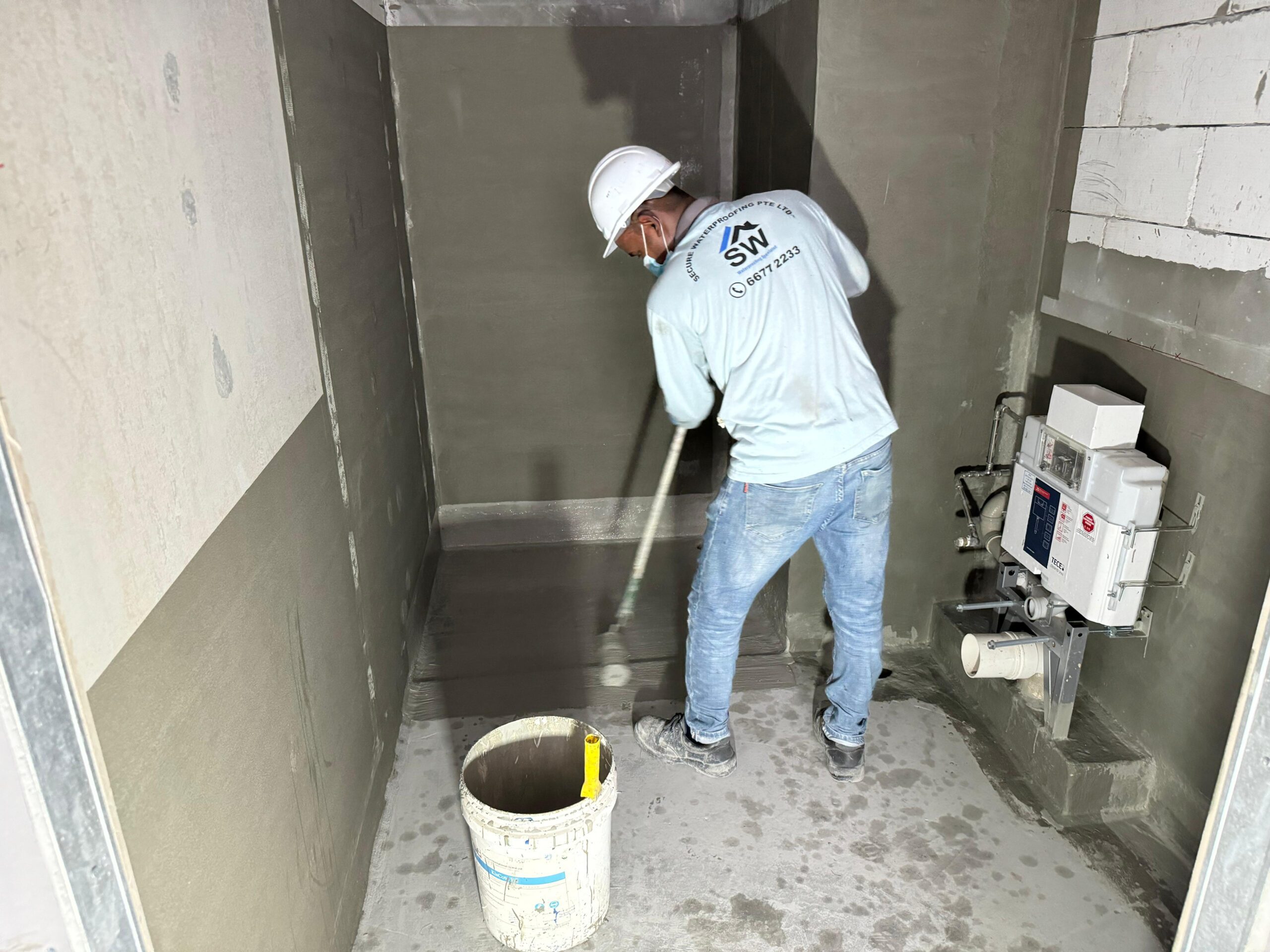 A waterproofing specialist coating the floor of a wet area or bathroom to provide long-term protection against internal moisture.