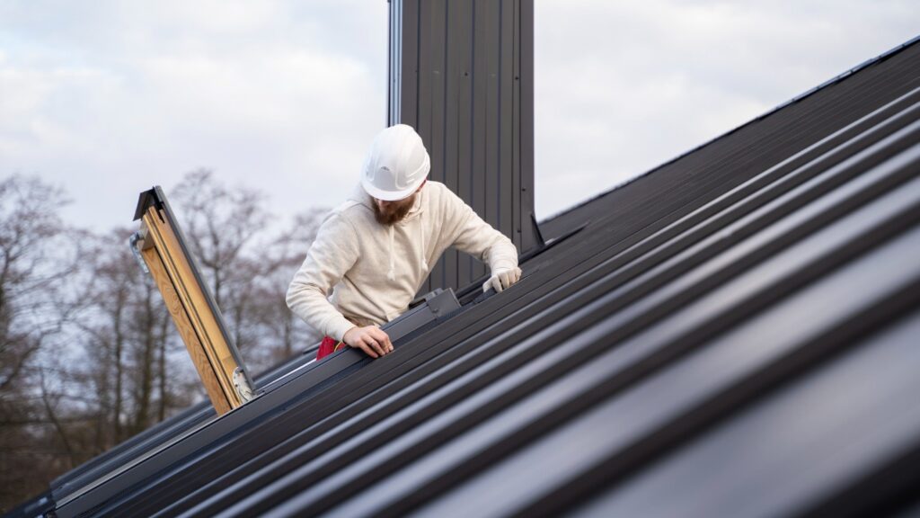 Roofing contractors inspecting a roof to identify recurring leaks and determine which roof type leaks most.