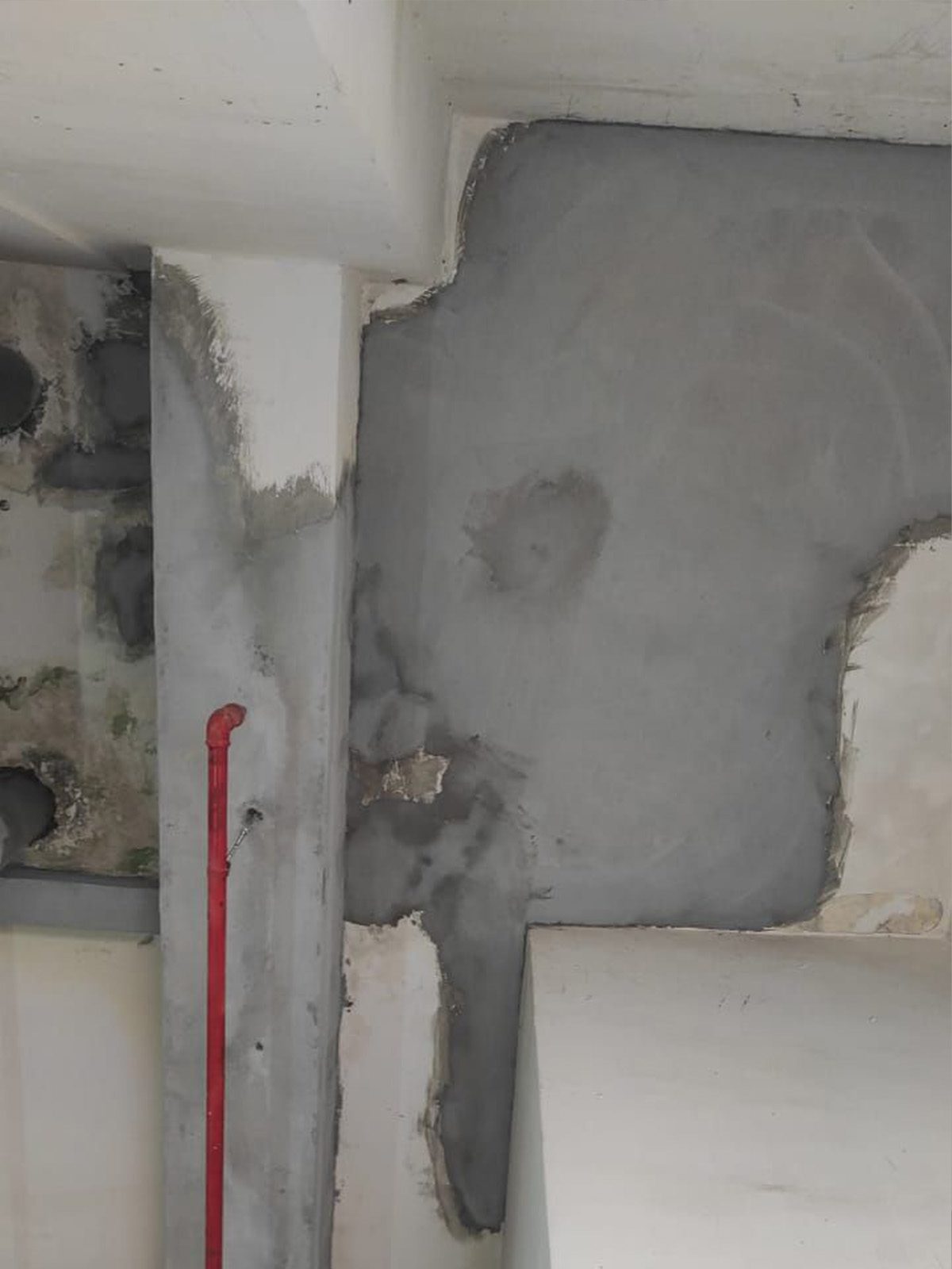 Concrete structure undergoing repair and restoration work by a professional waterproofing specialist to fix water ingress and damage.