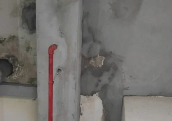 Concrete structure undergoing repair and restoration work by a professional waterproofing specialist to fix water ingress and damage.