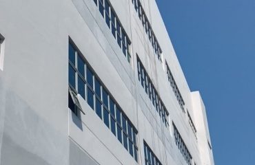 rope access team performing waterproofing works on commercial building in West Singapore by Secure waterproofing Specialist in Singapore
